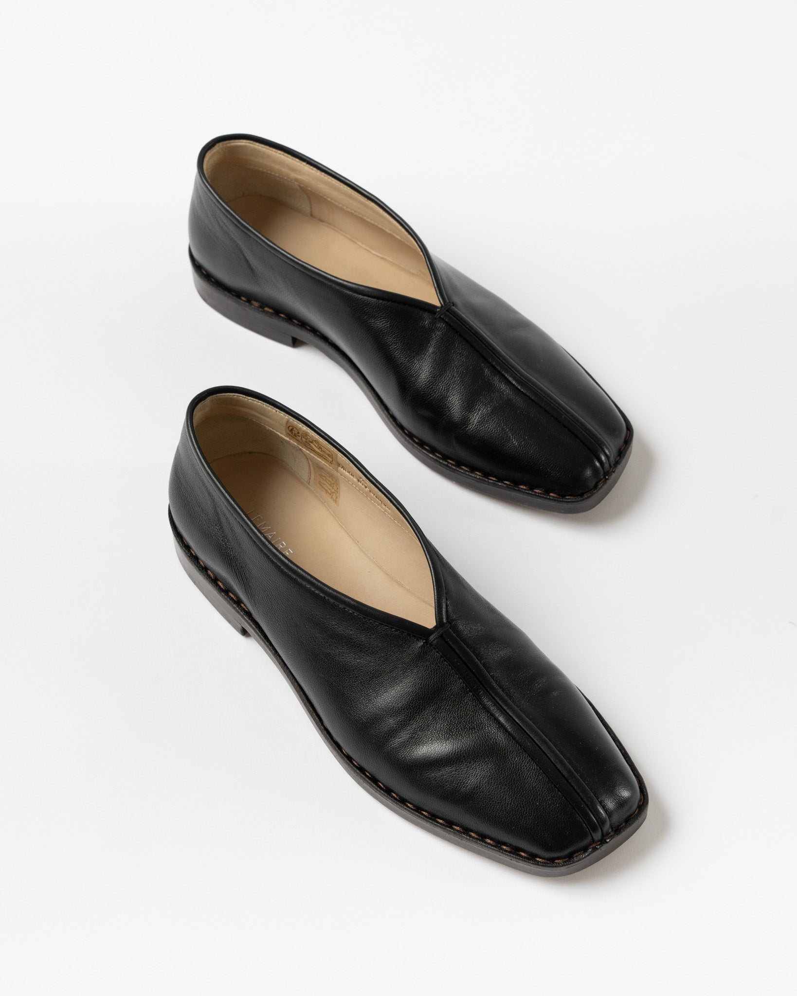 Lemaire Flat Piped Slippers in Black Curated at Jake and Jones
