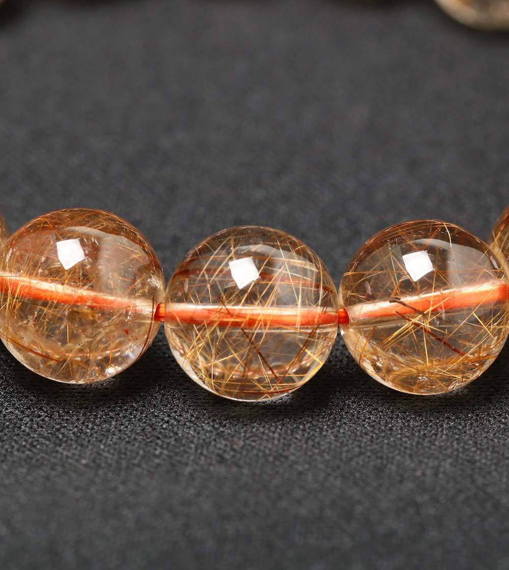 カラーの幅がとっても狭いオレンジルチルクォーツのブレスレット - 石
